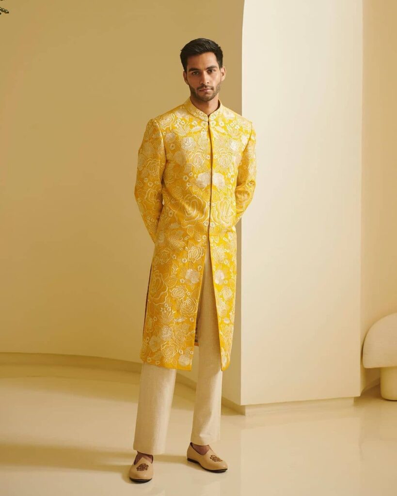Yellow color sherwani with off white churidar.